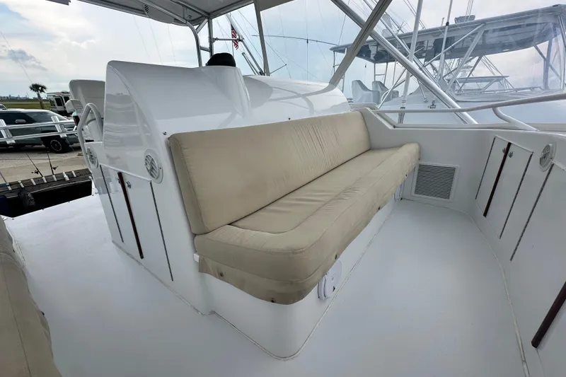 Slide: The Image of 2002 Hatteras 50 Convertible Sportfish boat interior with cushioned seating and sleek design. - 38