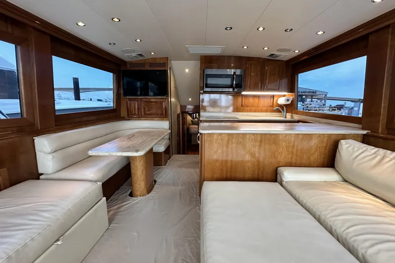 Slide: The Image of Luxurious interior of 2002 Hatteras 50 Convertible Sportfish yacht with modern kitchen and seating. - 45