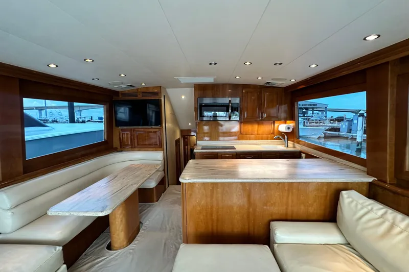 Slide: The Image of Luxurious interior of 2002 Hatteras 50 Convertible Sportfish yacht with wood finishes and seating. - 46