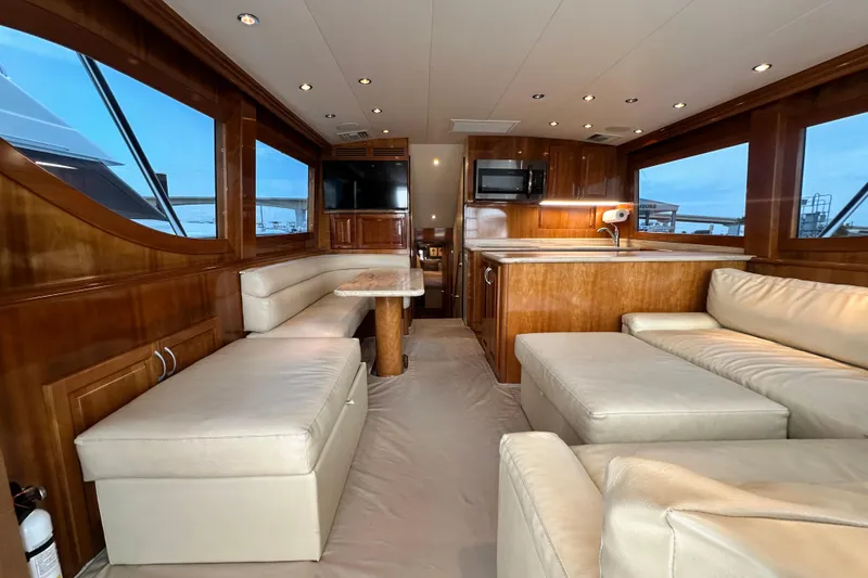 Slide: The Image of Luxurious interior of a 2002 Hatteras 50 Convertible Sportfish yacht with leather seating and wood finishes. - 47