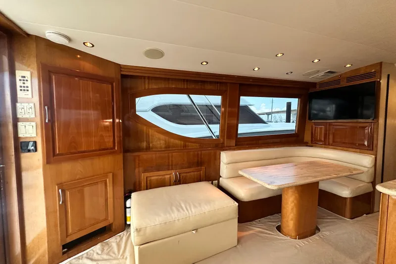 Slide: The Image of Luxurious interior of 2002 Hatteras 50 Convertible Sportfish with wood paneling and dining area. - 49