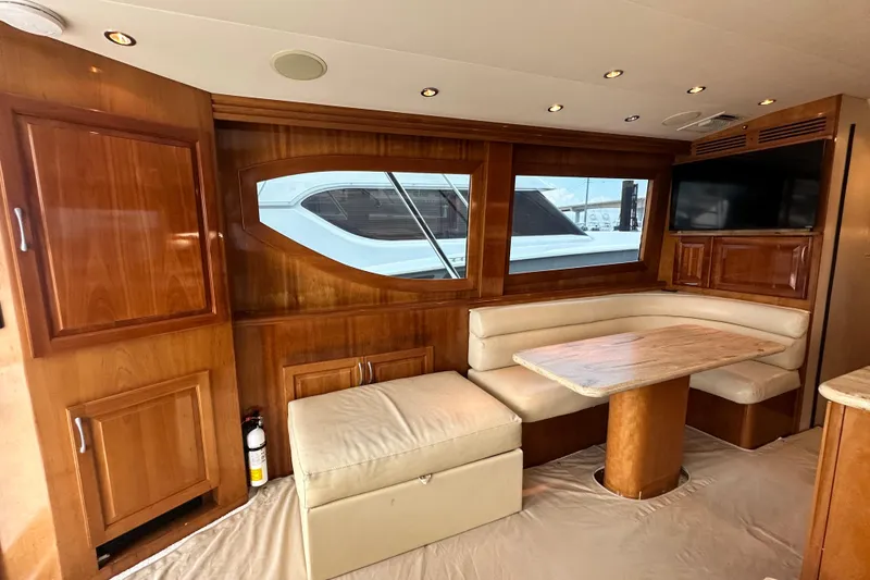 Slide: The Image of Luxurious interior of 2002 Hatteras 50 Convertible Sportfish yacht with wood finish and seating area. - 50