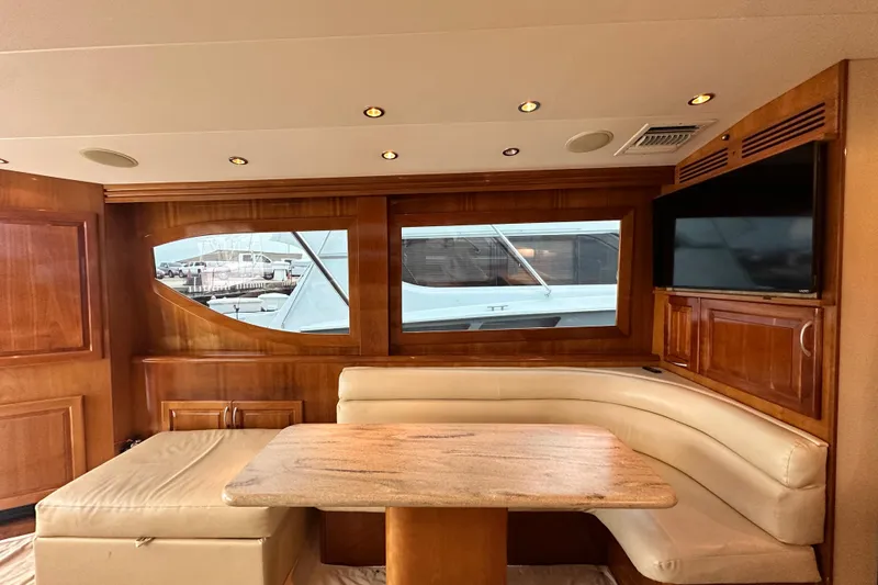 Slide: The Image of Interior of 2002 Hatteras 50 Convertible Sportfish with wood paneling and beige seating. - 51
