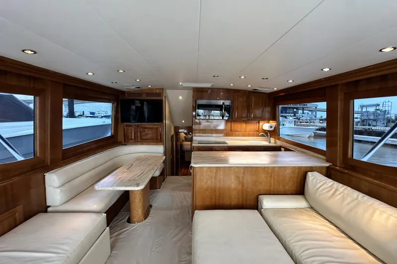 Slide: The Image of Luxurious interior of 2002 Hatteras 50 Convertible Sportfish yacht with wood finishes and seating. - 53