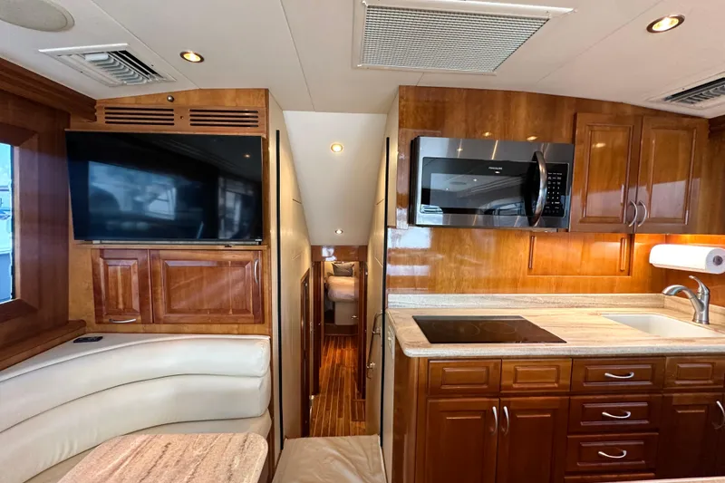 Slide: The Image of Interior of 2002 Hatteras 50 Convertible Sportfish with kitchen and seating area. - 56