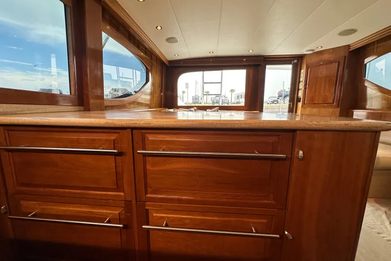 Slide: The Image of Luxurious interior of 2002 Hatteras 50 Convertible Sportfish with wooden cabinetry and large windows. - 61