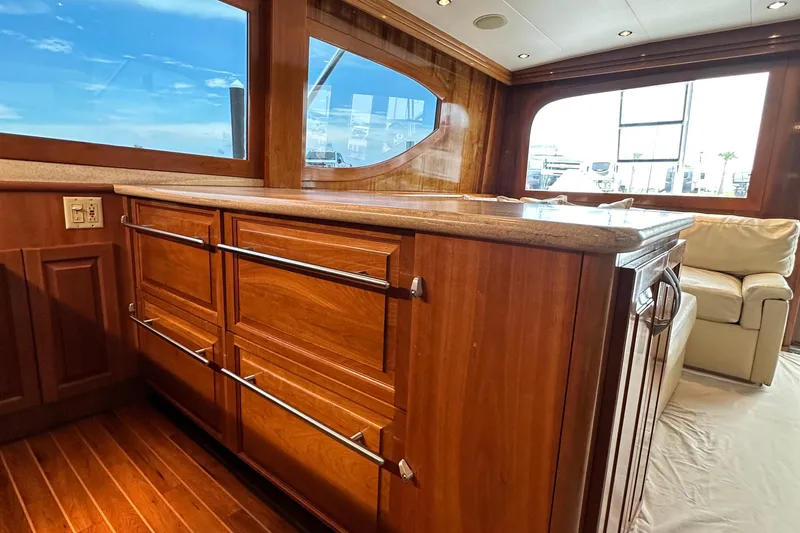Slide: The Image of Luxurious interior of 2002 Hatteras 50 Convertible Sportfish with wooden cabinetry and plush seating. - 62