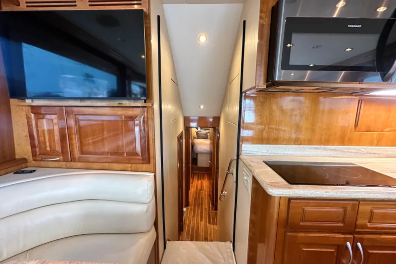 Slide: The Image of Interior of 2002 Hatteras 50 Convertible Sportfish with modern kitchen and cozy seating area. - 63