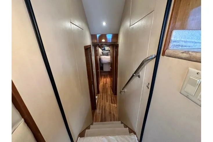 Slide: The Image of Interior hallway of 2002 Hatteras 50 Convertible Sportfish yacht with wooden flooring. - 66