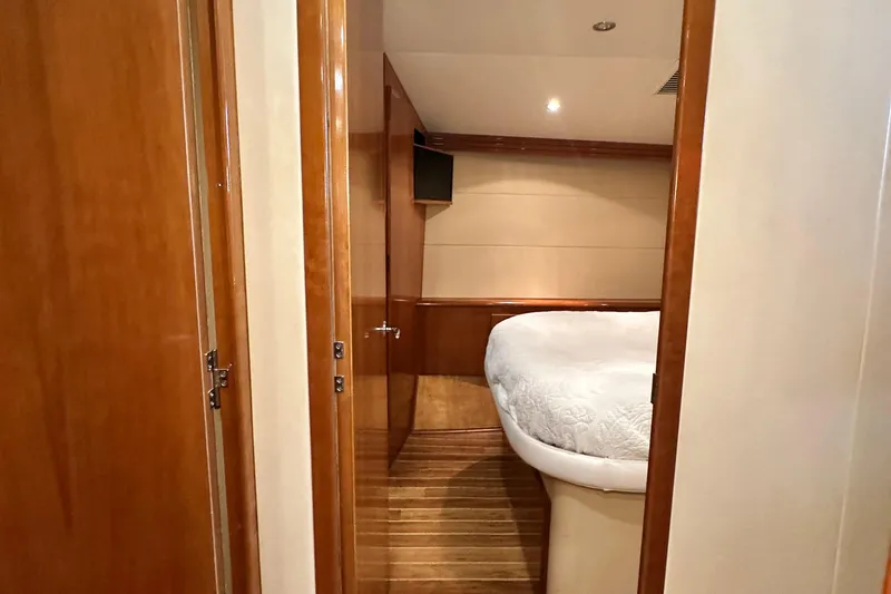 Slide: The Image of Interior cabin of 2002 Hatteras 50 Convertible Sportfish with wood paneling and cozy bed. - 68