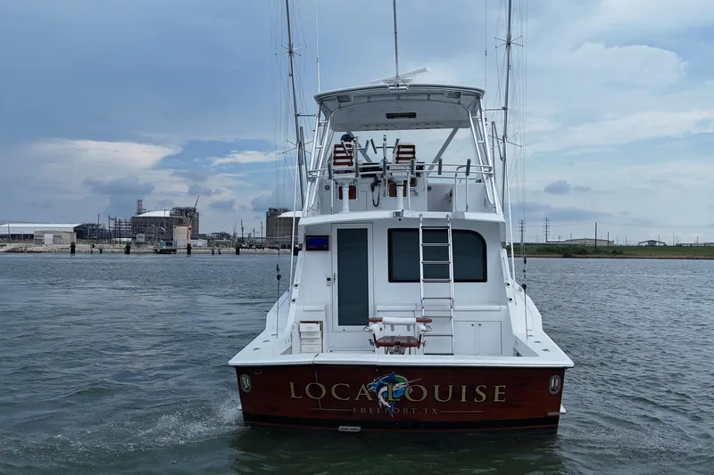 Slide: The Image of 2002 Hatteras 50 Convertible Sportfish boat on water, rear view, overcast sky. - 7