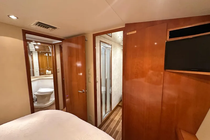 Slide: The Image of Luxurious interior of 2002 Hatteras 50 Convertible Sportfish yacht with wood finishes and ensuite bathroom. - 75