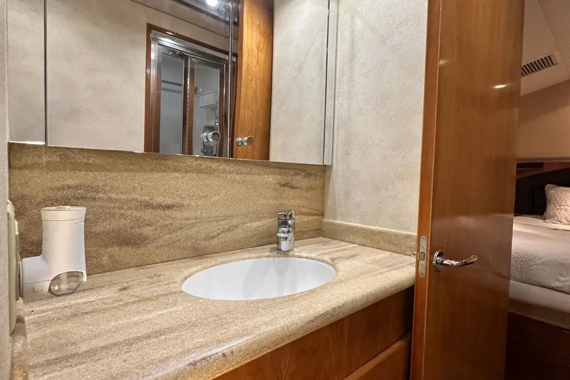 Slide: The Image of Bathroom interior of 2002 Hatteras 50 Convertible Sportfish yacht with modern sink and mirror. - 78