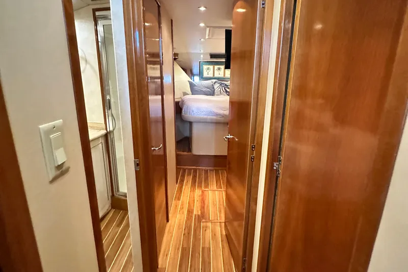 Slide: The Image of Interior of 2002 Hatteras 50 Convertible Sportfish, featuring wood paneling and cozy bedroom. - 83