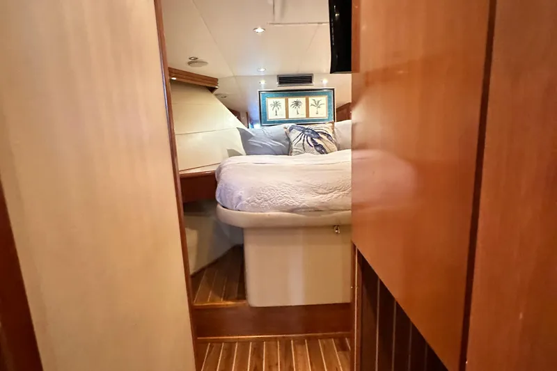 Slide: The Image of Interior cabin of 2002 Hatteras 50 Convertible Sportfish with cozy bed and wooden decor. - 84