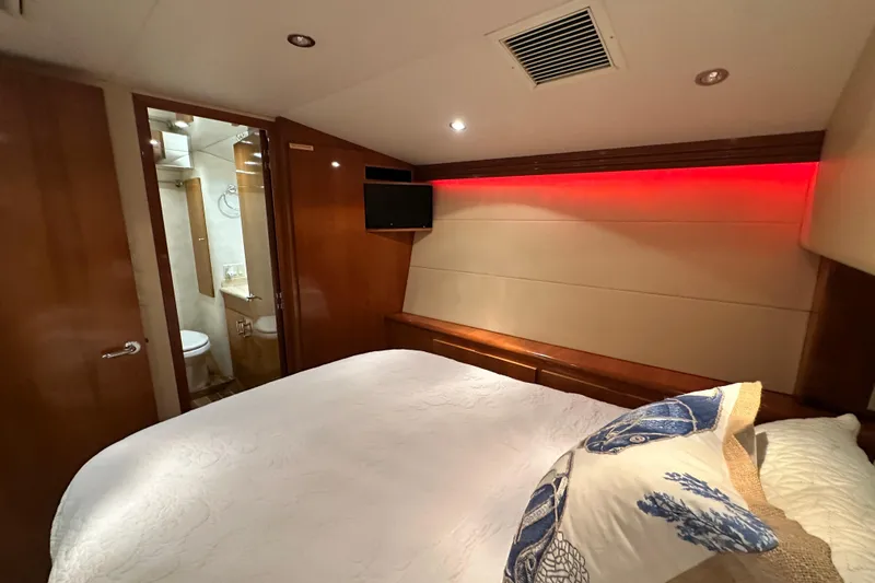 Slide: The Image of Bedroom interior of 2002 Hatteras 50 Convertible Sportfish with ensuite bathroom and modern lighting. - 88