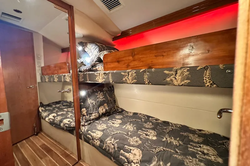 Slide: The Image of 2002 Hatteras 50 Convertible Sportfish cabin with bunk beds and animal-themed bedding. - 96