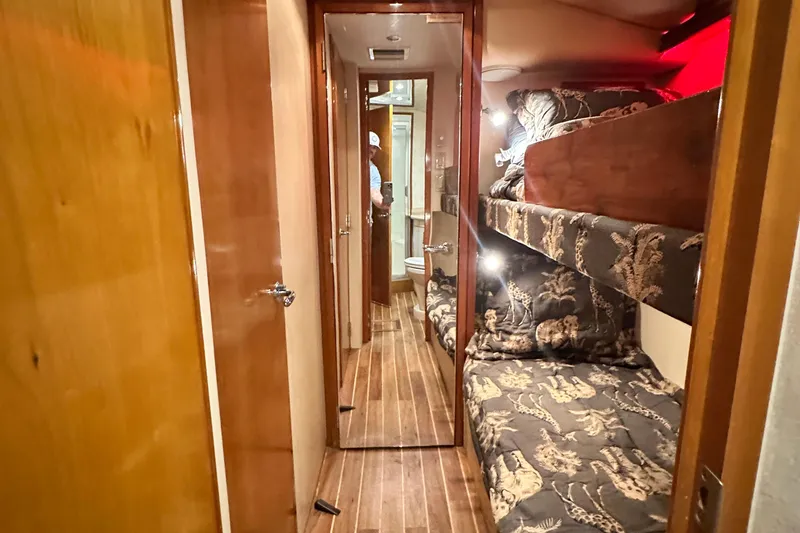 Slide: The Image of Interior of 2002 Hatteras 50 Convertible Sportfish with bunk beds and wooden flooring. - 97