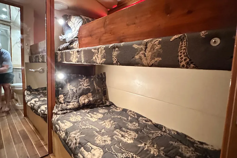 Slide: The Image of Bunk beds with safari-themed bedding in 2002 Hatteras 50 Convertible Sportfish yacht cabin. - 98
