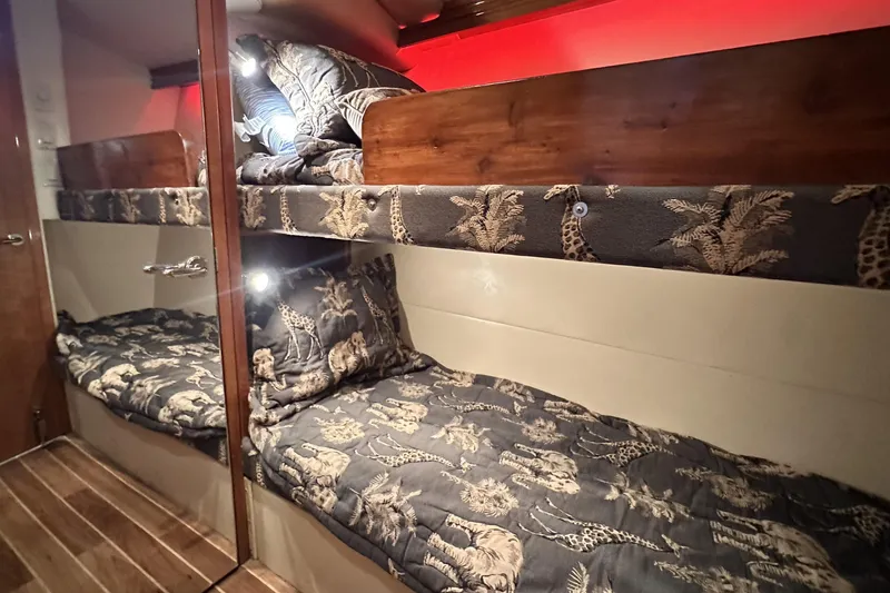 Slide: The Image of Bunk beds with animal print bedding in 2002 Hatteras 50 Convertible Sportfish yacht cabin. - 99