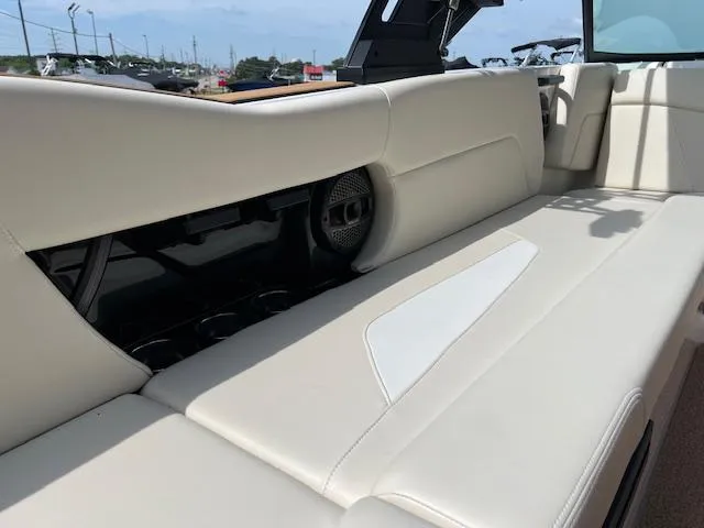 Slide: The Image of 2025 MasterCraft NXT23 boat interior with beige seating and speaker detail. - 21