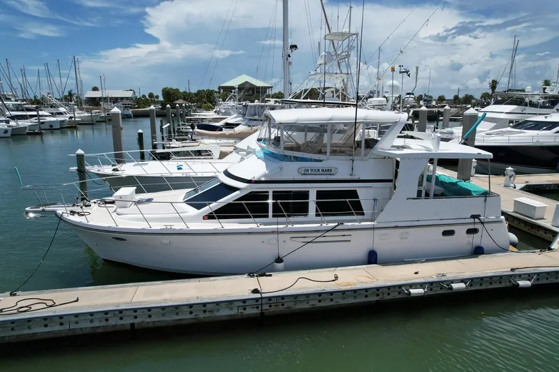 Slide: The Image of 2005 Jefferson Rivanna 50 SDMY yacht docked at marina under clear sky. - 0
