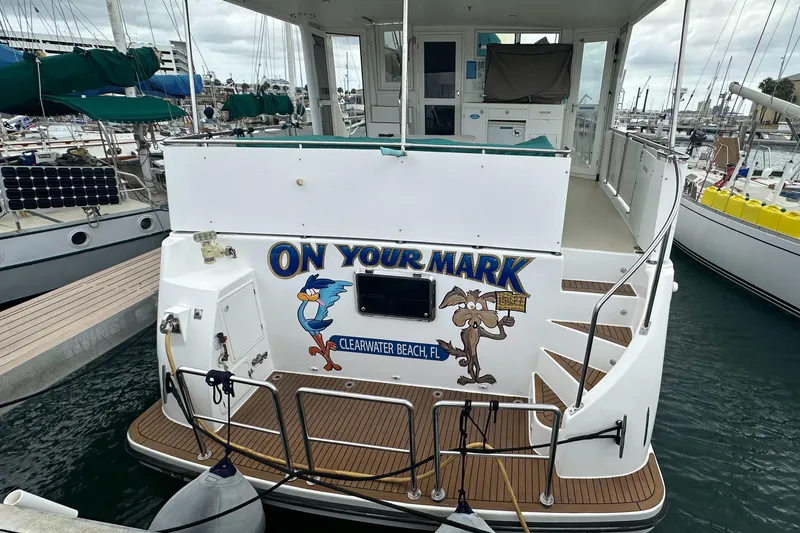 Slide: The Image of 2005 Jefferson Rivanna 50 SDMY yacht docked, featuring cartoon characters and "On Your Mark" text. - 10
