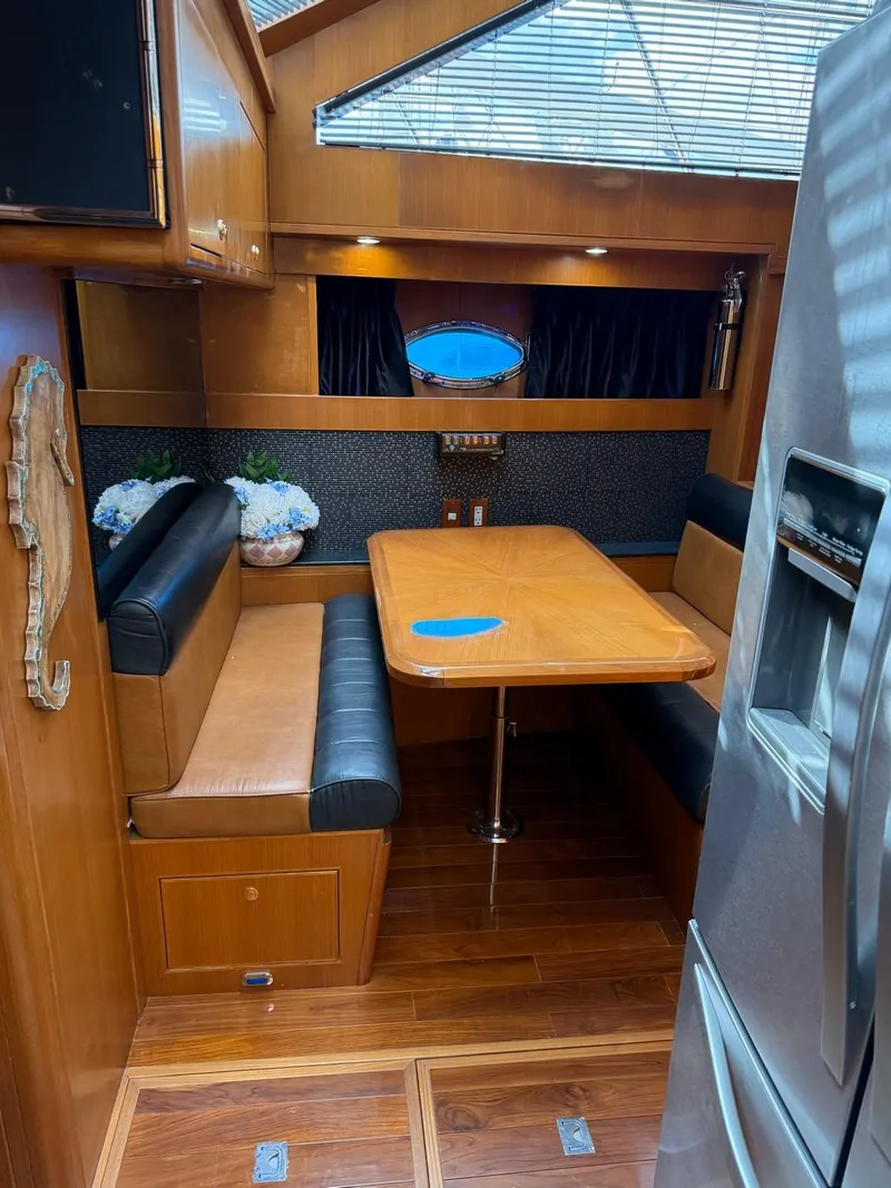 Slide: The Image of 2005 Jefferson Rivanna 50 SDMY yacht interior with dining area, wood finish, and modern appliances. - 16