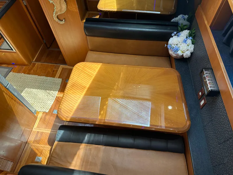 Slide: The Image of Interior of 2005 Jefferson Rivanna 50 SDMY with wooden table and leather seating. - 18