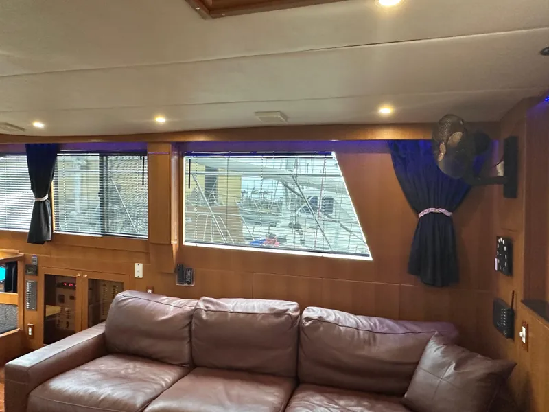 Slide: The Image of Interior of 2005 Jefferson Rivanna 50 SDMY yacht with leather sofa and large windows. - 21