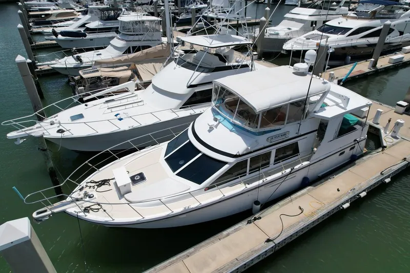 Slide: The Image of 2005 Jefferson Rivanna 50 SDMY yacht docked at marina, surrounded by other boats. - 3