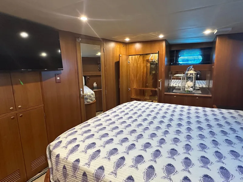 Slide: The Image of Luxurious bedroom interior of 2005 Jefferson Rivanna 50 SDMY yacht with wood paneling and TV. - 33