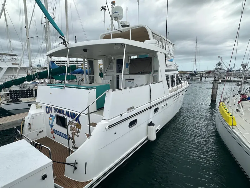 Slide: The Image of 2005 Jefferson Rivanna 50 SDMY yacht docked in a marina under cloudy skies. - 8