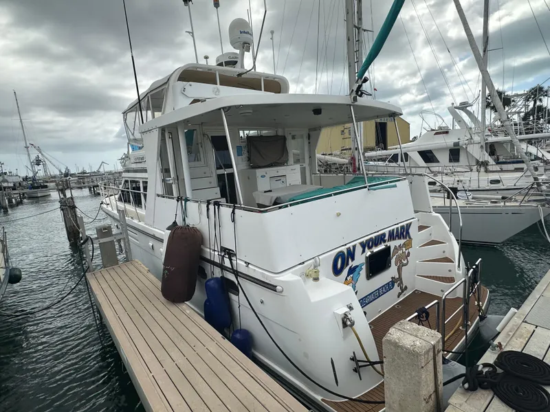 Slide: The Image of 2005 Jefferson Rivanna 50 SDMY yacht docked at marina under cloudy skies. - 9
