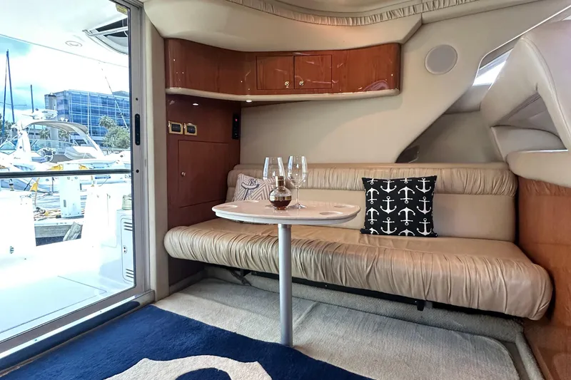 Slide: The Image of Interior of 2001 Sea Ray 400 Sedan Bridge with cozy seating and nautical decor. - 15