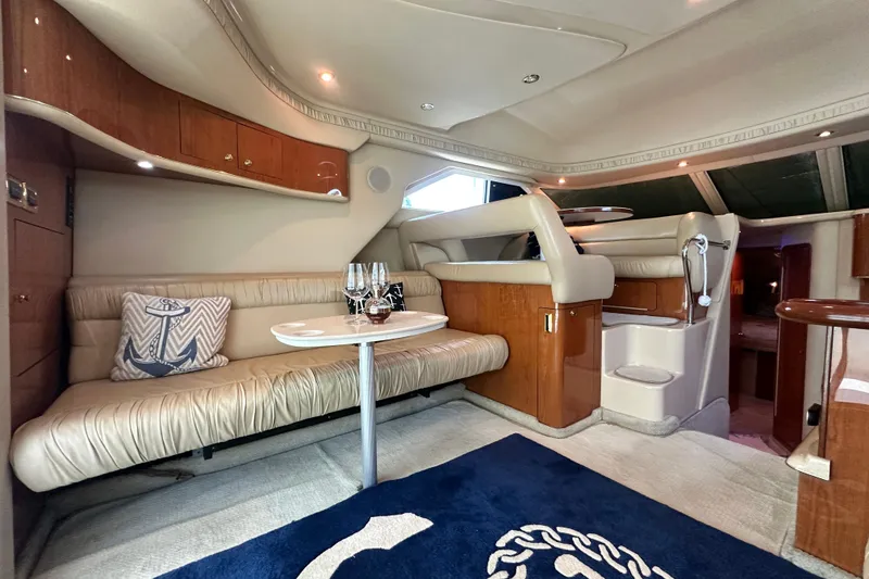 Slide: The Image of Luxurious interior of 2001 Sea Ray 400 Sedan Bridge yacht with plush seating and elegant decor. - 19