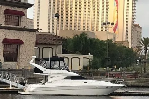 Slide: The Image of 2001 Sea Ray 400 Sedan Bridge yacht docked near urban buildings. - 2