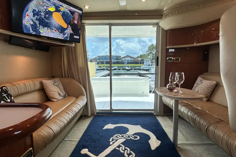Slide: The Image of Luxurious interior of 2001 Sea Ray 400 Sedan Bridge yacht with marina view. - 20