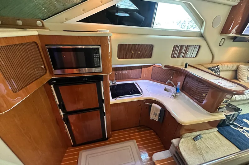Slide: The Image of Luxurious 2001 Sea Ray 400 Sedan Bridge yacht interior with modern kitchen amenities. - 26