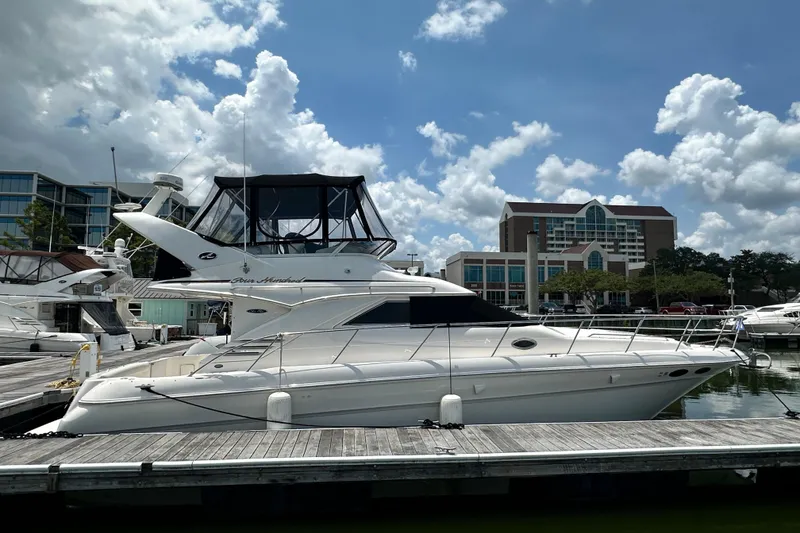 Slide: The Image of 2001 Sea Ray 400 Sedan Bridge yacht docked at marina under blue sky. - 3