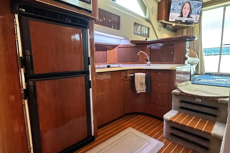 Slide: The Image of Luxurious 2001 Sea Ray 400 Sedan Bridge yacht interior with kitchen and stairs. - 31