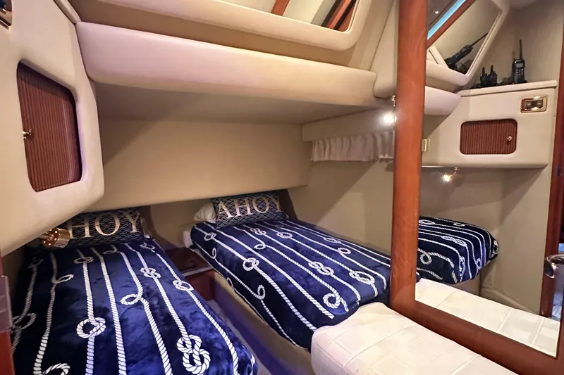 Slide: The Image of Interior cabin of 2001 Sea Ray 400 Sedan Bridge with twin beds and nautical decor. - 35