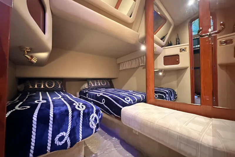 Slide: The Image of 2001 Sea Ray 400 Sedan Bridge cabin with twin beds and nautical decor. - 38