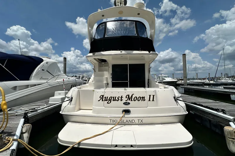 Slide: The Image of 2001 Sea Ray 400 Sedan Bridge yacht docked at marina, named "August Moon II". - 4