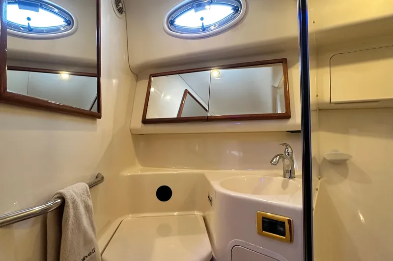 Slide: The Image of Bathroom interior of 2001 Sea Ray 400 Sedan Bridge yacht, featuring sink and mirror. - 43