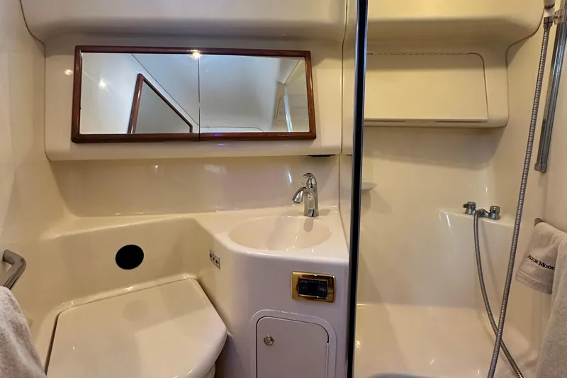 Slide: The Image of 2001 Sea Ray 400 Sedan Bridge bathroom with sink, mirror, and shower area. - 44