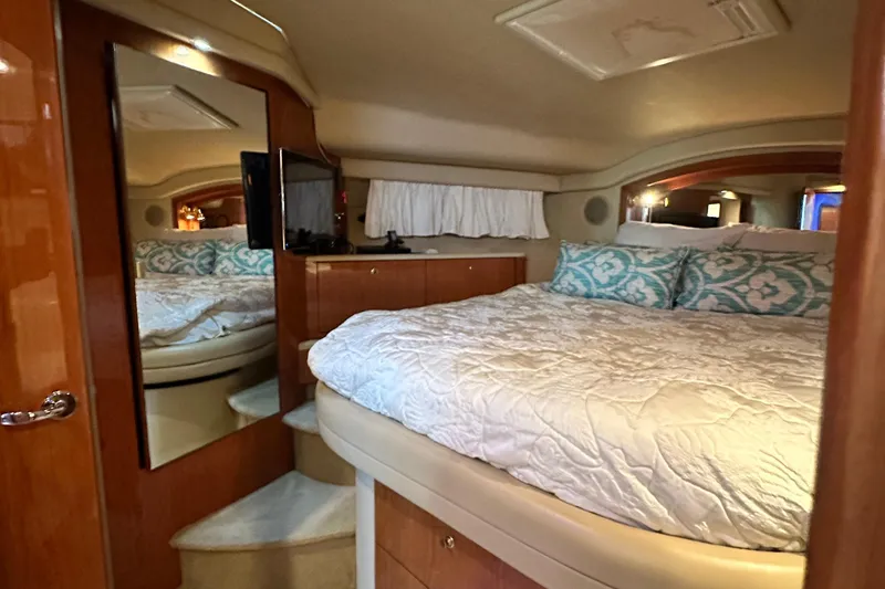 Slide: The Image of Luxurious 2001 Sea Ray 400 Sedan Bridge bedroom with cozy bedding and elegant wood finishes. - 49