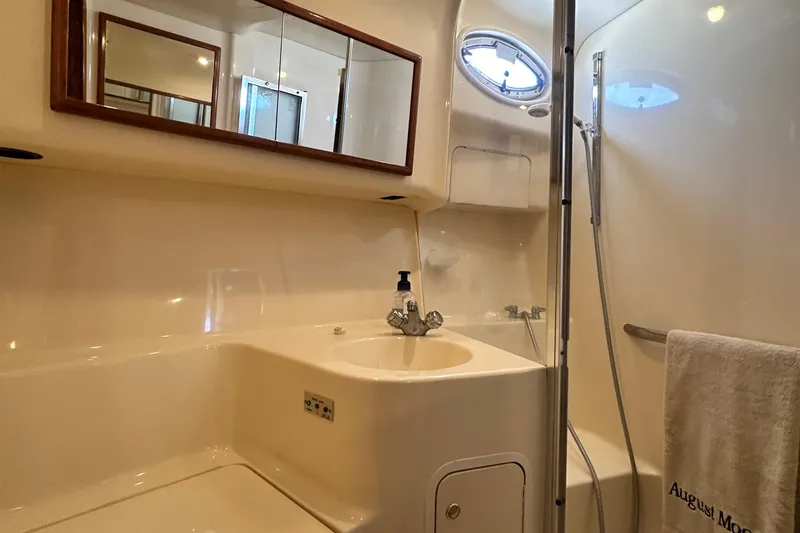 Slide: The Image of Bathroom interior of 2001 Sea Ray 400 Sedan Bridge yacht, featuring sink and shower. - 50