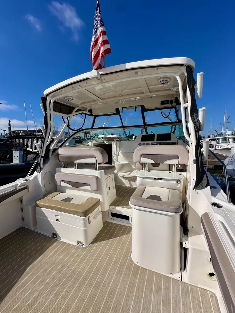 Slide: The Image of 2018 Wellcraft 290 Coastal boat interior with seating and American flag. - 13