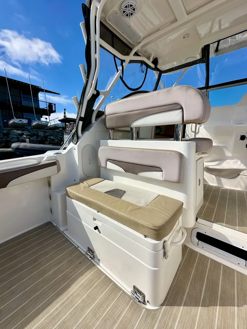 Slide: The Image of 2018 Wellcraft 290 Coastal boat interior with cushioned seating and sleek design. - 14